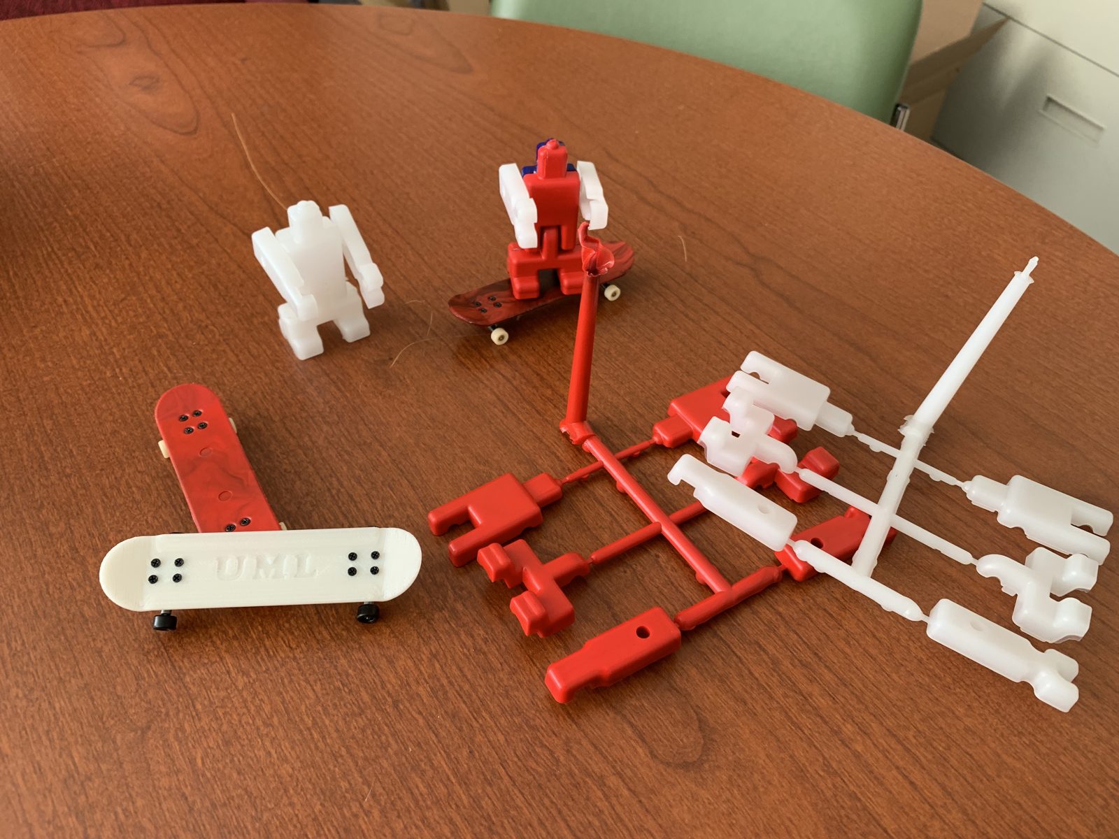 Finished plastic parts molded by students, still attached to the runner system