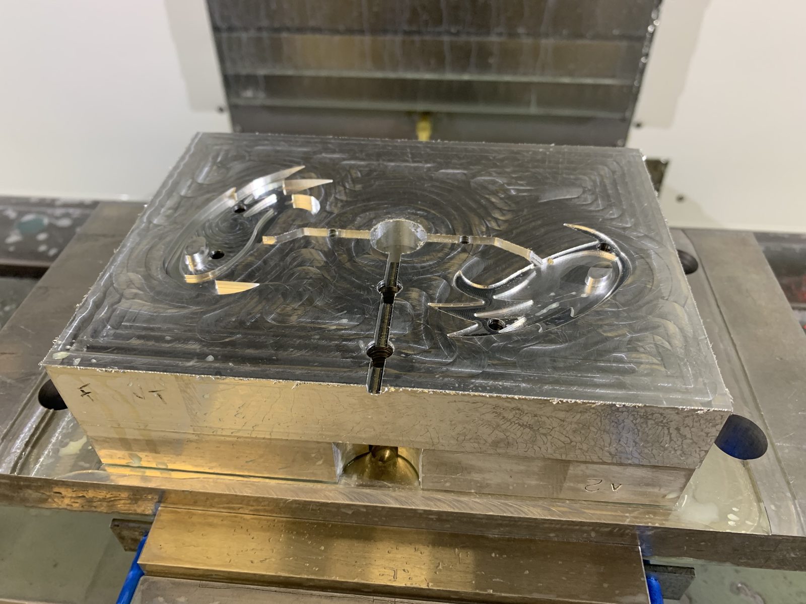 A student-machined aluminum mold plate, mounted on a CNC milling machine